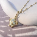 Detailed macro view of 18K gold sea turtle necklace with blue enamel and starfish patterns - Blue Sea Turtle