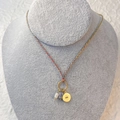 Detail of colorful braided rope necklace with pearl, stone and golden sun eye charm - Eye (Multi-color Cord/Gray Blue Natural Stone)