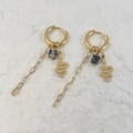 Detail of gold drop earrings with sleek snake charm and navy blue marbled cube bead - Snake