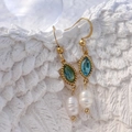 Vue détaillée de boucles d'oreilles en acier avec zircons colorés et perles d'eau douce - Ovale-Bleu