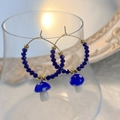 Detail of blue glass mushroom earrings with gold metal hoops and faceted beads - Dark Blue