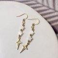 Detail of gold star earrings with white shell pentagrams and hollow star pendants - Four-pointed Star Style
