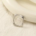 Macro shot of polished silver geometric square ring on a cream textured fabric background - US 6 / Steel