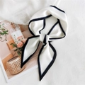 Elegant ivory silk neck scarf with black border trim tied in a stylish knot - White with Black Edge