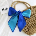 Blue and cyan silk scarf tied in a bow on a straw bag for summer vacation styling - Royal Blue & Cyan