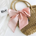 Pink silk ribbon bow tied on a straw bag handle, elegant fashion scarf hair tie accessory - Pink and Beige