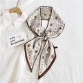 Elegant paisley print twilly scarf in beige and brown tied as a decorative bow - Beige Paisley Lily (17)