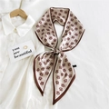 Vintage beige silk scarf with coffee patterns tied in a bow on a white shirt - TM Skin Tone (21)