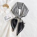 Classic black and white houndstooth silk-feel skinny scarf tied as a bow on a white shirt - Black Windmill Pattern (4)