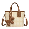 Chic beige quilted bucket bag with brown trim and cute leather puppy charm accessory - Apricot