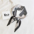 Elegant black and white striped long silk scarf displayed on a white professional shirt - Dual Color Wave Geometric