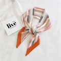 Fashionable long silk scarf featuring orange and blue geometric stripes tied in a knot - Color Block Geometric Orange