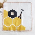 Square silk scarf with giraffe and geometric pattern on stylish straw bag backdrop - Hexagonal Giraffe