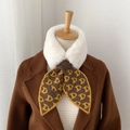 Detail of knitted scarf with D-pattern jacquard and plush faux fur collar texture - Brown Yellow Letter D Pattern
