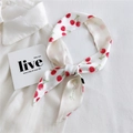 Slim white Twilly silk scarf with red cherry print and green floral font on a white shirt - Cute Cherry Print (18K Cherry)