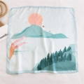 Elegant square silk scarf featuring a blue landscape print with sunset and mountains - Rising Sun Gold