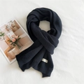 Solid black thick knit scarf with decorative label and ribbed hem for winter warmth - 36x190cm / Black