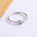 Adjustable silver Evil Eye ring with blue gemstone and white zircon stones on white background - White Gold