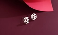 Macro shot of 925 sterling silver pentagram star stud earrings on a purple background - Hollow Pentagram Circle (F3)
