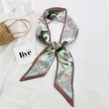Blue narrow silk scarf with swan and lotus floral prints on a white shirt background - 19L Crane Lotus Camel