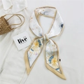 Slim cream silk scarf with gold trim and celestial sun moon patterns on a straw bag - 28L Constellation Beige