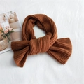 Thick caramel brown ribbed knit scarf for women shown in a cozy knotted style - Caramel color