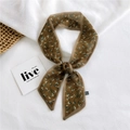 Brown long skinny scarf with delicate floral print tied in a bow on white linen - Chiffon Floral Print Brown
