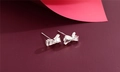 Detailed macro view of S925 sterling silver bow earrings with polished finish and engraving - Bowknot Style (F5)