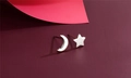 Macro view of S925 silver star and moon asymmetrical stud earrings on colorful backdrop - Star & Moon Asymmetric (F14)