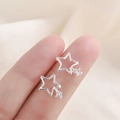 925 silver hollow star stud earrings with dangling zircon crystals held in hand - Silver Hollow Pentagram (A33)