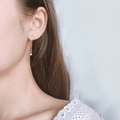 Asymmetric silver drop earrings with round rhinestones and sleek metal bar on model - Silver Asymmetric Long Style (A57)