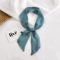 Gray-blue chiffon neck scarf with white square dots tied in a knot on a woven mat - Chiffon Geometric Dots Green