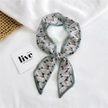 Elegant skinny scarf featuring green leaf patterns and pink base on white background - Chiffon Banana Leaf Green