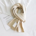 Thick ribbed knit scarf in creamy beige color with a small woven label for winter warmth - Beige