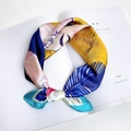 Artistic abstract print silk scarf in bright yellow and blue tied on a white magazine - 1 Cat Girl