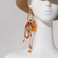 Bohemian long tassel earrings with amber resin ring and floral silk ribbons on model - Amber Ring With Orange Floral Ribbon(26328)