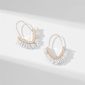 Detailed view of bohemian V-shaped fringe earrings with white beads and gold metal frame - White