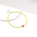 Detail of yellow seed bead choker with red starfish pendant and silver extender chain - Yellow