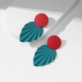 Detail of red and dark green leaf drop earrings on a white minimalist geometric pedestal - Red & Blue (E24)