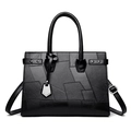 Schwarze Patchwork-Handtasche aus geometrischem Kunstleder mit runden Griffen - Schwarz