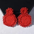 Handmade red beaded earrings featuring geometric woven patterns in a ethnic fashion style - Red