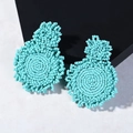 Handmade woven seed bead earrings in vibrant turquoise blue color with geometric circles - Blue