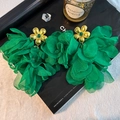Detail shot of oversized green organza flower earrings with gold metal and emerald stones - Green