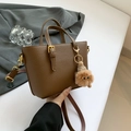 Brown litchi grain leather bucket bag with plush charm and adjustable strap - Light Brown With Pendant