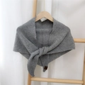 Grey knitted triangle scarf shawl with leather label accent on a wooden hanger - Gray