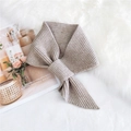Oatmeal knit scarf with ribbed texture in a warm criss-cross overlapping style - Beige