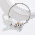 Close-up of stainless steel wire bracelet with dragonfly, heart crystal and handmade charms - White