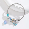 Silver stainless steel wire bracelet with blue dragonfly and purple heart charms - Light Blue