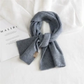 Chunky knit gray winter scarf with stylish brown leather patch detail on white background - Medium Grey