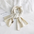 Solid minimalist cream knit scarf for women with brown side label on white fabric - Beige